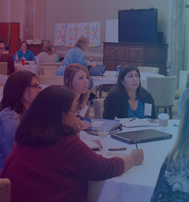 Group of counselors at a table, engaged in conversation