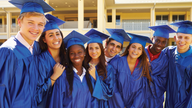 Group of grads smiling at camera