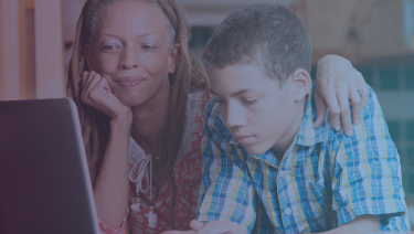 Woman and child sitting at computer